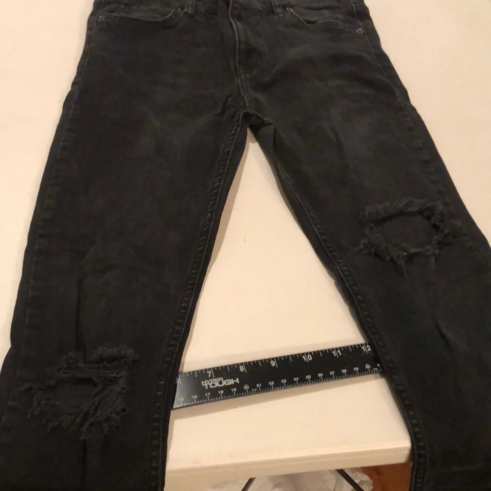 Free People size 27 Black Wash skinny jeans distressed with raw hem